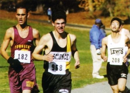 Three people running at a cross country meet.